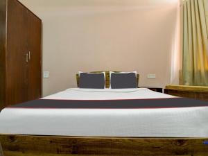 ein Bett in einem Zimmer mit einem großen weißen Bett in der Unterkunft Collection O Aqualura Verem Rd in Goa