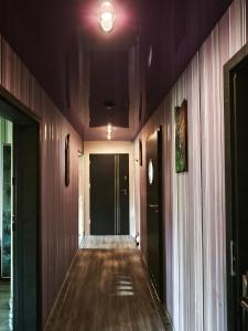 an empty hallway with wood paneled walls and a ceiling at Apartament Gościnne Gniazdo in Gliwice