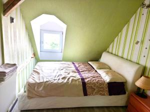 a bedroom with a bed in a room with a window at Apartament Gościnne Gniazdo in Gliwice