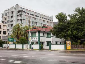 a building on the side of a street with a building at Lai Ming Hotel Cosmoland in Singapore