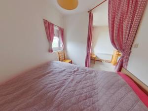 a bedroom with a bed in a room with curtains at Studio lumineux avec loggia aux Rousses - FR-1-834-12 in Les Rousses