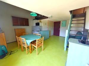 a kitchen and dining room with a table and chairs at Appartement lumineux pour 6 pers au centre de Prémanon - FR-1-834-13 in Prémanon