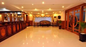 a lobby with a bar and a table and chairs at Jun Yue Hotel in Phnom Penh