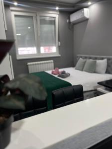 a small room with a bed and a couch at Apartman Hram Zvornik in Zvornik