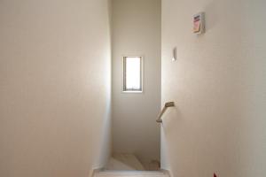 a stairway with a small window in a room at kafuulivimg sobe in Yomitan +23 photos