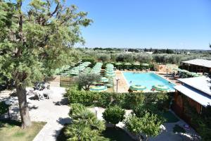 an overhead view of a pool with umbrellas and chairs at Il Sogno Apartments in Alberobello