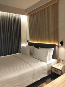 Ένα ή περισσότερα κρεβάτια σε δωμάτιο στο Beezie Hotel