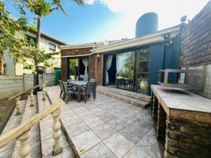 a patio with a table and chairs and a building at Broadway Shark Guest House in Margate