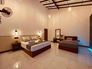 a large bedroom with a bed and a mirror at The Wasa Heaven in Hiriketiya