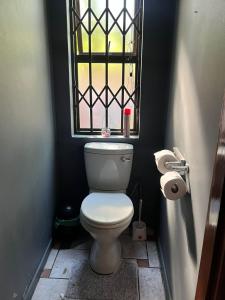 a bathroom with a toilet with a window at Broadway Shark Guest House in Margate +13 photos