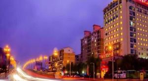 a city street at night with buildings and street lights at Tong Da International Hotel in Zhangjiajie