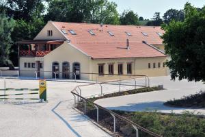a large building with a red roof and a ramp at Královický Dvůr in Slaný