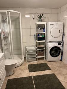 a bathroom with a washing machine and a washer at Cozy place near Pulpit Rock in Strand