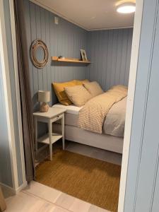 a small bedroom with a bed and a table at Cozy place near Pulpit Rock in Strand