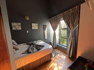 a bedroom with a bed and a window at Broadway Shark Guest House in Margate