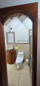 a bathroom with a toilet and a sink at Casa Santiago Son 2 in Antigua Guatemala +18 photos