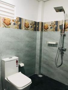 a bathroom with a shower and a toilet in it at Rhythm Transit Hotel - Near Airport in Katunayaka +60 photos