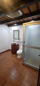 a bathroom with a toilet and a sink at Casa Santiago Son 2 in Antigua Guatemala