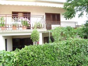 a building with a balcony with plants on it at House Krk in Krk