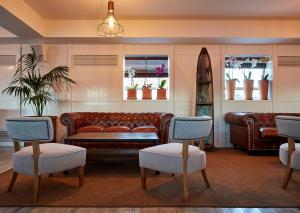 a living room with a couch and two chairs at Delamar 4*Sup-Adults only (18+) in Lloret de Mar