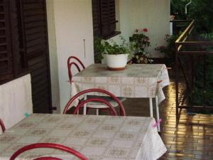 a table and chairs on a porch with a table and a table and chairs at House Krk in Krk
