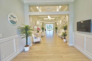 a hallway of a hospital with potted plants at Seaside Escape in Fort Pierce