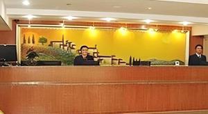 a woman sitting at a desk in a courtroom at Hanting Hotel Beijing National Stadium Branch in Beijing