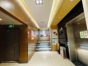 a hallway of a building with stairs and signs at Jinjiang Inn Tai'an Taishan Railway Station in Tai'an