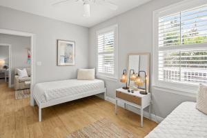 a white room with a bed and a mirror at Sweet Bay on 30A in Seagrove Beach +53 photos