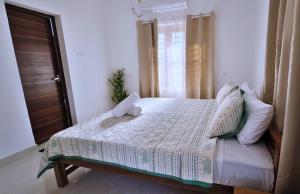 a bedroom with a bed and a window at Gypsy Walker Plus in Varkala