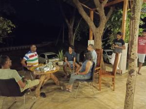 a group of people sitting around a table at Elephant Arcade in Tissamaharama
