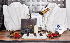 a table with a bottle of champagne and some strawberries at Delamar 4*Sup-Adults only (18+) in Lloret de Mar
