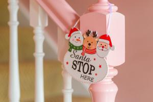 a christmas stocking ornament hanging on a stair rail at Lilys Pink House in Mayobridge