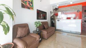 a waiting room with two chairs and a tv at RedDoorz @ Gerlins Lodge Two in Manila