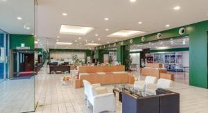 a lobby of a store with white chairs and tables at Hamakan Hotel in Unzen +210 photos