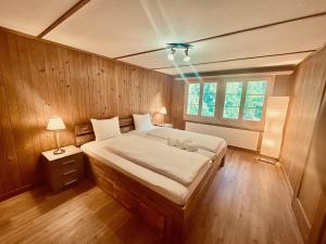 Ένα ή περισσότερα κρεβάτια σε δωμάτιο στο Scenic Stay Grindelwald Interlaken & Lauterbrunen +11 φωτογραφίες