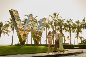 a group of people standing in front of a sculpture at W Dubai - The Palm in Dubai +166 photos