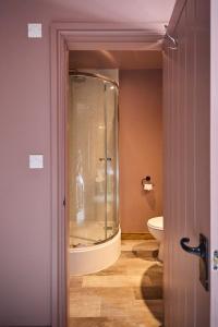 a bathroom with a glass shower and a toilet at The Bulls Head in Belper