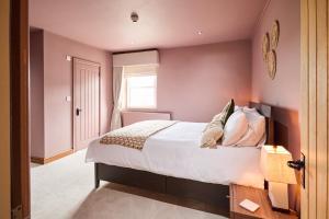 a bedroom with a bed and a window at The Bulls Head in Belper