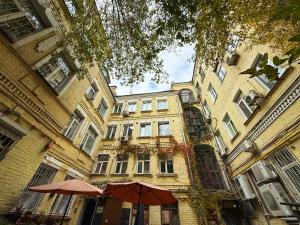 a large building with an umbrella in front of it at Kyiv Gelik Apartment in Kyiv