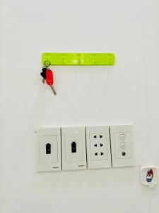 a bunch of electrical sockets with a pair of keys at AHK Homestay 1 in Phu Quoc