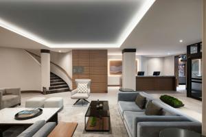 a living room with a couch and a table at AC Hotel by Marriott Old Montreal in Montréal