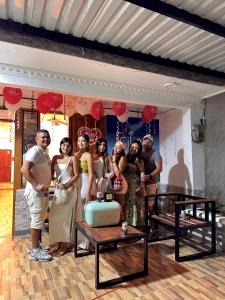 a group of people posing for a picture at a party at Hostal Cilipo in Palomino