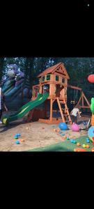 a playground with a slide and a play house at Bongalow bamboo in San Giorgio a Liri