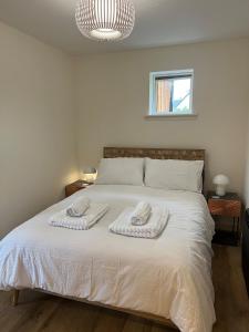 a bedroom with a bed with two towels on it at Scandi style Cottage by the sea, Isle of Skye in Portree
