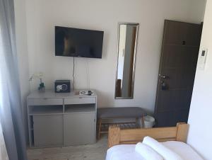 a bedroom with a bed and a tv on a wall at Luxury suites Marušić sobe in Brodski Varoš +18 photos