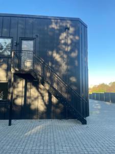 a glass building with a staircase on the side of it at Beauty sleep Guldager in Esbjerg
