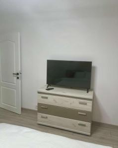 a television sitting on top of a dresser at Cristian's Home in Drobeta-Turnu Severin