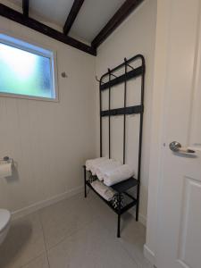 a towel rack in a bathroom with a toilet and a window at Maleny-Montville Cottages #4 - 2 bed with ocean view in Maleny