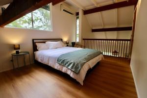 a bedroom with a bed and a large window at Maleny-Montville Cottages #4 - 2 bed with ocean view in Maleny